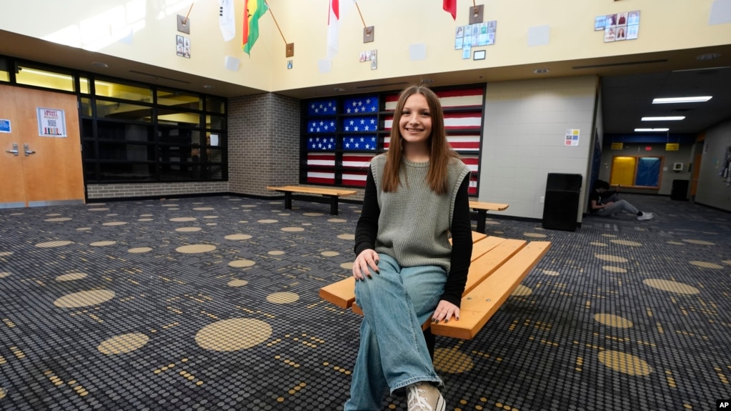 Makenzie Gilkison sits in a lobby at Greenfield Central High School in Greenfield, Indiana, Dec. 17, 2024.