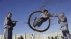 An Afghan policeman demonstrates skills during a graduation ceremony in Herat, west of Kabul, Dec. 20, 2012.