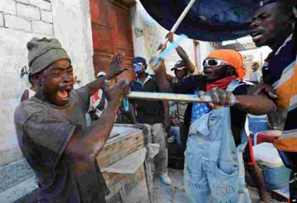 Haitian earthquake victims beat a looter in Port-au-Prince , 21 Jan 2010 - AFP