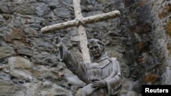 A statue of Father Junipero Serra stands at Mission San Juan Capistrano in California. Pope Francis will confer sainthood on the controversial 18th century Spanish missionary during his visit to Washington, Sept. 23, 2015.