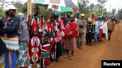 People queue as they wait to cast their votes in the Kenya election in Gatundu in Kiambu county, Kenya, Aug. 8, 2017.