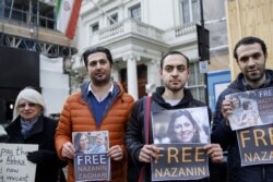 FILE - Campaigners hold posters of jailed British-Iranian woman Nazanin Zaghari-Ratcliffe at the Iranian Embassy in London on February 21, 2018.