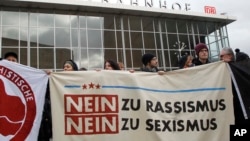 People protest in front of the main station in Cologne, Germany, on Wednesday, Jan. 6, 2016.