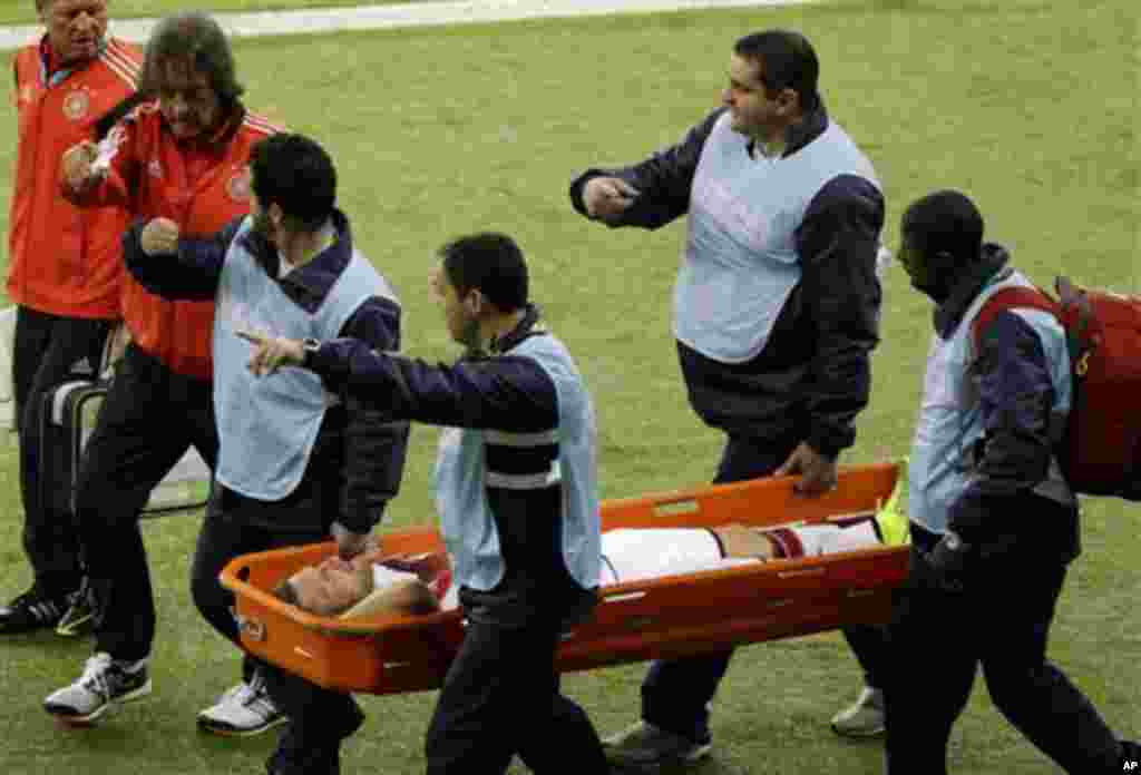 Germany's Shkodran Mustafi is carried off the field after suffering an injury during the World Cup round of 16 soccer match between Germany and Algeria at the Estadio Beira-Rio in Porto Alegre, Brazil, Monday, June 30, 2014. (AP Photo/Thanassis Stavrakis)