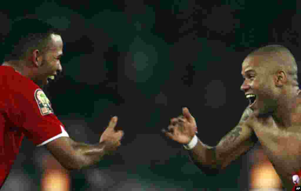 Equatorial Guinea's Iban Iyanga (L) and Kily Alvarez celebrate after their team won the opening match against Libya during the African Nations Cup soccer tournament in Estadio de Bata "Bata Stadium", in Bata January 21, 2012.