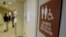 FILE- A sign marks the entrance to a gender-neutral restroom at the University of Vermont in Burlington, Vermont.