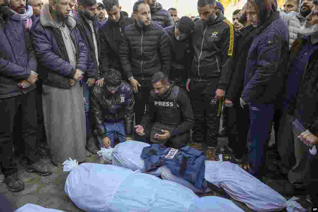 Colleagues and friends mourn over the body of freelance journalist Omar al-Derawi and other victims of overnight Israeli army strikes at multiple locations in central Gaza Strip, at Al-Aqsa Martyrs Hospital in Deir al-Balah.