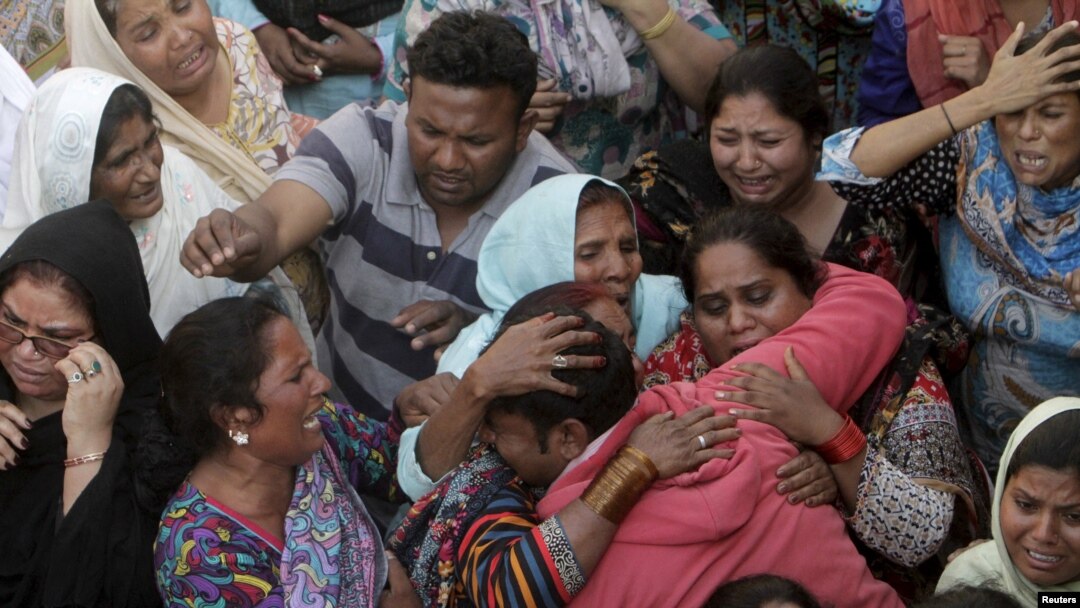 Family members mourn the death of a relative, who was killed in a blast outside a public park on Sunday, during funeral in Lahore, Pakistan, March 28, 2016.