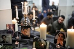 Photographs of student victims of a Ukrainian passenger jet which crashed in Iran are seen during a vigil at University of Toronto student housing in Toronto, Canada Jan. 8, 2020.