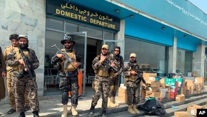 Taliban fighters stand guard inside the Hamid Karzai International Airport after the U.S. withdrawal in Kabul, Afghanistan, Aug. 31, 2021. The Taliban were in control of the airport Tuesday, after the last US left its runway.