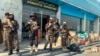 Taliban fighters stand guard inside the Hamid Karzai International Airport after the U.S. withdrawal in Kabul, Afghanistan, Aug. 31, 2021. The Taliban were in control of the airport Tuesday, after the last US left its runway.