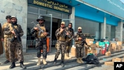 Taliban fighters stand guard inside the Hamid Karzai International Airport after the U.S. withdrawal in Kabul, Afghanistan, Aug. 31, 2021. The Taliban were in control of the airport Tuesday, after the last US left its runway.