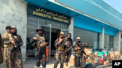 FILE - Taliban fighters stand guard inside Hamid Karzai International Airport after the U.S. withdrawal in Kabul, Afghanistan, Aug. 31, 2021. The Taliban were in control of the airport after the last U.S. plane left its runway.