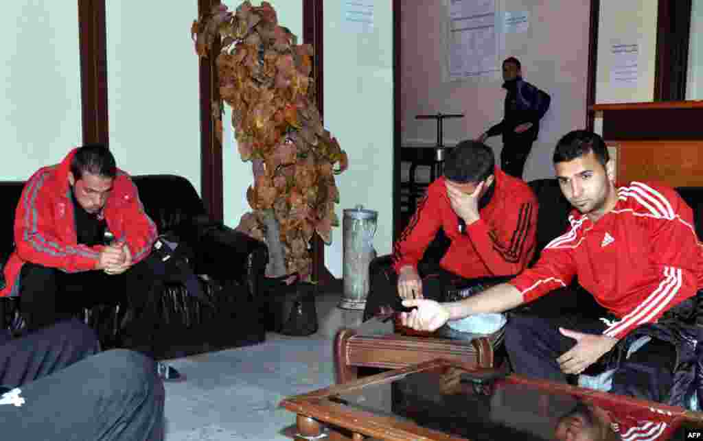 Players of the Homs-based Al-Wathba football react after a mortar fell as they were training at the Tishreen Sport City Stadium on the outskirts of Damascus, February 20, 2013.