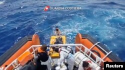 Coast guard members rescue survivors of a boat that had set off from Libya a few days ago, and shipwrecked near the Sicilian island of Lampedusa, Italy, Sept. 4, 2024, in this screen grab from video. (Guardia Costiera/Handout via Reuters)