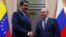 FILE PHOTO: Russian President Vladimir Putin, right, shakes hands with his Venezuelan counterpart Nicolas Maduro during a meeting at the Novo-Ogaryovo state residence outside Moscow, Russia Dec. 5, 2018. 