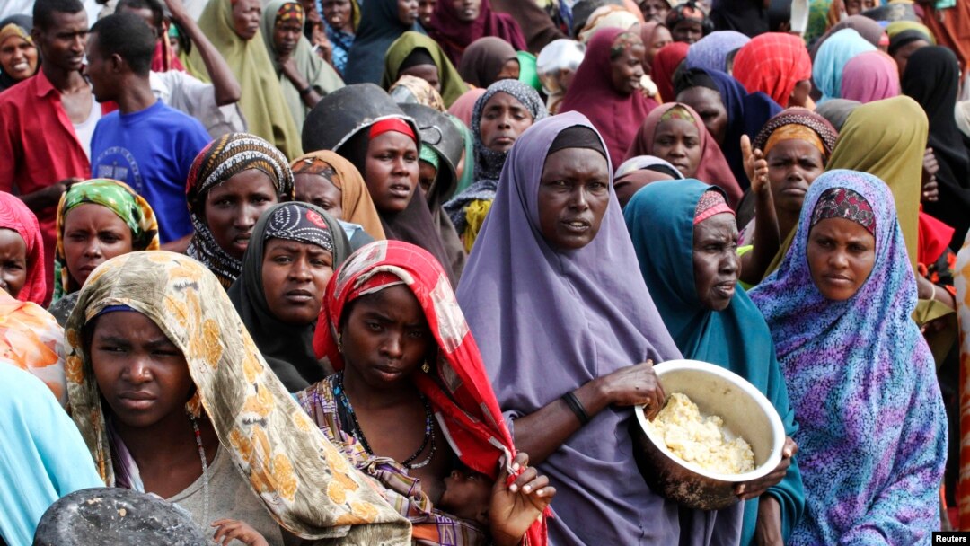  Internally displaced Somali women wait for food at a camp in the capital Mogadishu, July 2011.