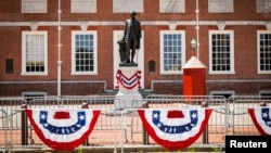 A statue of George Washington is displayed along the route of a parade in Philadelphia, Pennsylvania.