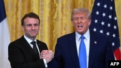 US President Donald Trump and French President Emmanuel Macron shake hands at the end of a joint press conference in the East Room to the White House in Washington, DC, on February 24, 2025. (Photo by ROBERTO SCHMIDT / AFP)