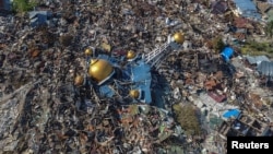 An aerial view of an area devastated by an earthquake in Palu, Central Sulawesi, Indonesia October 1, 2018 in this photo taken by Antara Foto.