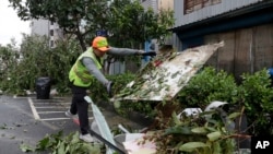 A sanitation worker of Kaohsiung city government clears debris in the aftermath of Typhoon Krathon in Kaohsiung, southern Taiwan, Oct. 4, 2024.