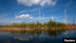 FILE - An Ares test rocket sits on a launch pad at the Kennedy Space Center in Cape Canaveral, Florida.