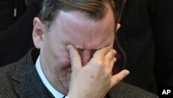 Left-wing Thuringia incumbent governor Bodo Ramelow wipes his eyes as he sits in the Thuringian state parliament during the election of its new governor, in Erfurt, Germany, Feb. 5, 2020.