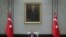 Turkey's President Recep Tayyip Erdogan, backdropped by a painting depicting modern Turkey's founder Mustafa Kemal Ataturk, chairs his government's cabinet in Ankara, Turkey, April 26, 2021.