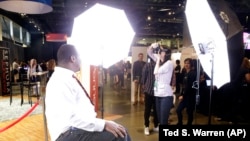 FILE - Dwight Walton, of Seattle, has a photo taken for his LinkdIn social networking profile at a job fair in Seattle sponsored by the 100,000 Opportunities Initiative. (AP Photo/Ted S. Warren)