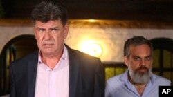 FILE - Efrain Alegre, left, of the GANAR alliance walks with his running mate, Leo Rubin, before speaking with the press in Lambare, Paraguay, April, 22, 2018.