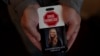 Matt Capelouto, whose daughter, Alexandra, died from a fentanyl overdose, holds an awareness card advocating for legal action against those responsible for drug-related deaths in Temecula, California, Sept. 17, 2024.