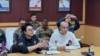 In this image provided by the Royal Thai Police, Chinese actor Wang Xing, right, talks with Thai police officers in Mae Sot district, in Thai-Myanmar border, Tak province, Jan. 7, 2025. 