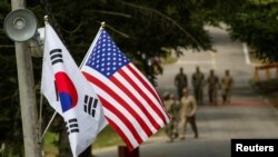 FILE - The South Korean and American flags fly next to each other at Yongin, South Korea.