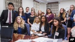 Survivors from Marjory Stoneman Douglas High School and other students from Broward County, Fla. high schools listen to Sen. Bobby Powell in his office at the Florida Capital in Tallahassee, Fla., Feb 20, 2018. (AP Photo/Mark Wallheiser)