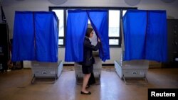 FILE - A voter leaves the booth after casting her ballot in the Pennsylvania primary at a polling place in Philadelphia, Pennsylvania.