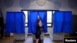 FILE - A voter leaves the booth after casting her ballot in the Pennsylvania primary at a polling place in Philadelphia, Pennsylvania.