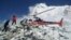 FILE - Helicopter prepares to rescue people at Everest Base Camp, which had been struck by an avalanche triggered by a massive earthquake in Nepal, April 27, 2015.