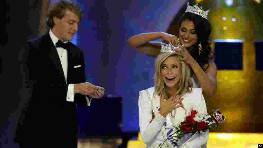 Miss America 2014 Nina Davuluri, top right, crowns Miss New York Kira Kazantsev as Miss America 2015 during the Miss America 2015 pageant in Atlantic City, New Jersey.