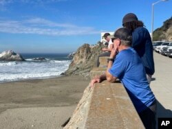 People watch waves slap San Francisco's Ocean Beach after an earthquake shook Northern California on Dec. 5, 2024.