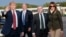 President Donald Trump and first lady Melania Trump on the tarmac during their arrival on Air Force One at Glasgow Prestwick Airport in Scotland, July 13, 2018. Secretary of State for Scotland, United Kingdom, David Mundell, second from right, greeted them.
