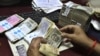 India's Currency Plunges to Record Low