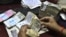An employee counts Indian rupee notes at a bank in Allahabad, India, May 16, 2012.