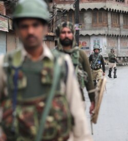 Indian paramilitary soldiers patrol a street in Srinagar, Indian-controlled Kashmir, Aug. 10, 2019. Authorities enforcing a strict curfew in Indian-administered Kashmir will bring in trucks of essential supplies for an Islamic festival next week.