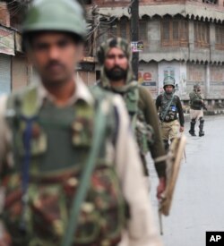 Indian paramilitary soldiers patrol a street in Srinagar, Indian-controlled Kashmir, Aug. 10, 2019.