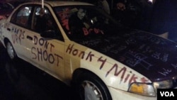 A car parked outside police headquarters in Ferguson, Missouri, carries its own messaging, conveyed via a reporter's tweet, on Nov. 21, 2014. 