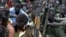 Boys with their rifles sit at a ceremony of the child soldiers disarmament, demobilization and reintegration in Pibor, Jonglei State, South Sudan, oversawn by UNICEF and partners, Feb. 10, 2015.