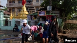 Anti-coup protesters are seen in a barricade area as they clash with security forces in Yangon, Myanmar, March 17, 2021. 