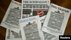 FILE - Front pages of major Australian newspapers show a "Your right to know" campaign, in Canberra, Australia, Oct. 21, 2019.