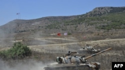 FILE - A handout picture released by the Turkish armed forces on Sept. 7, 2020, shows soldiers riding atop an M48 Patton during a military exercise in the self-proclaimed Turkish Republic of Northern Cyprus.