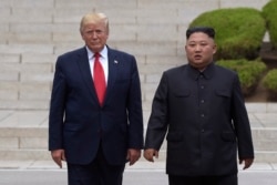 President Donald Trump, left, meets with North Korean leader Kim Jong Un at the North Korean side of the border at the village of Panmunjom in Demilitarized Zone, Sunday, June 30, 2019.